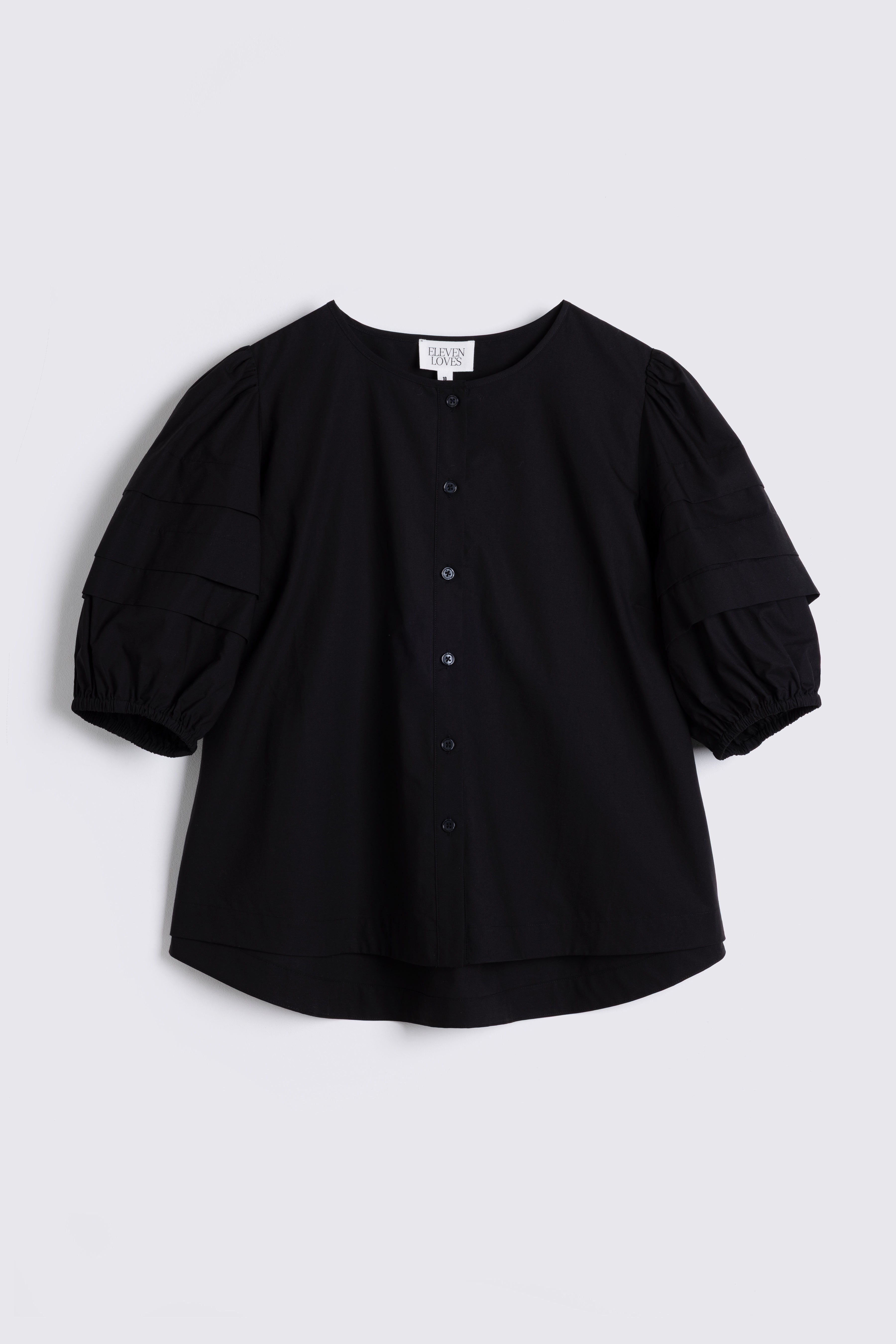 Black blouse with puff sleeves on a light gray background