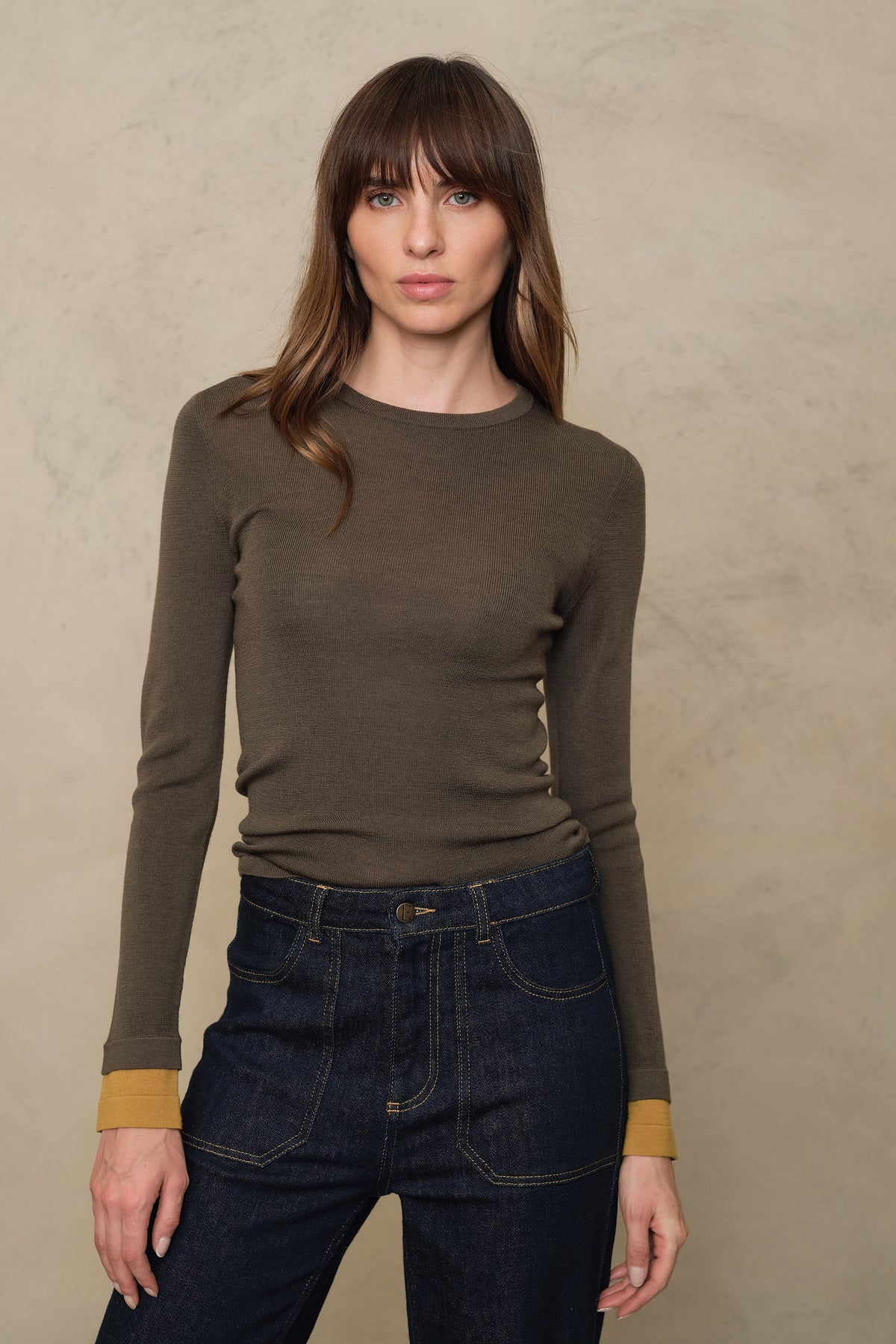 Trinny fine merino crewneck in dark olive with a mustard sleeve