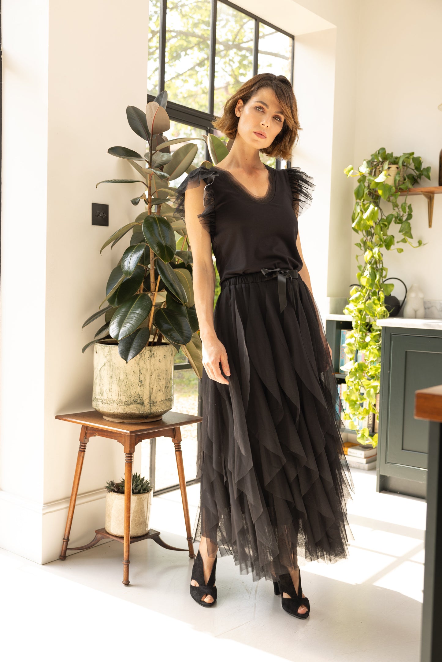 Tulle Skirt Black worn by model in kitchen