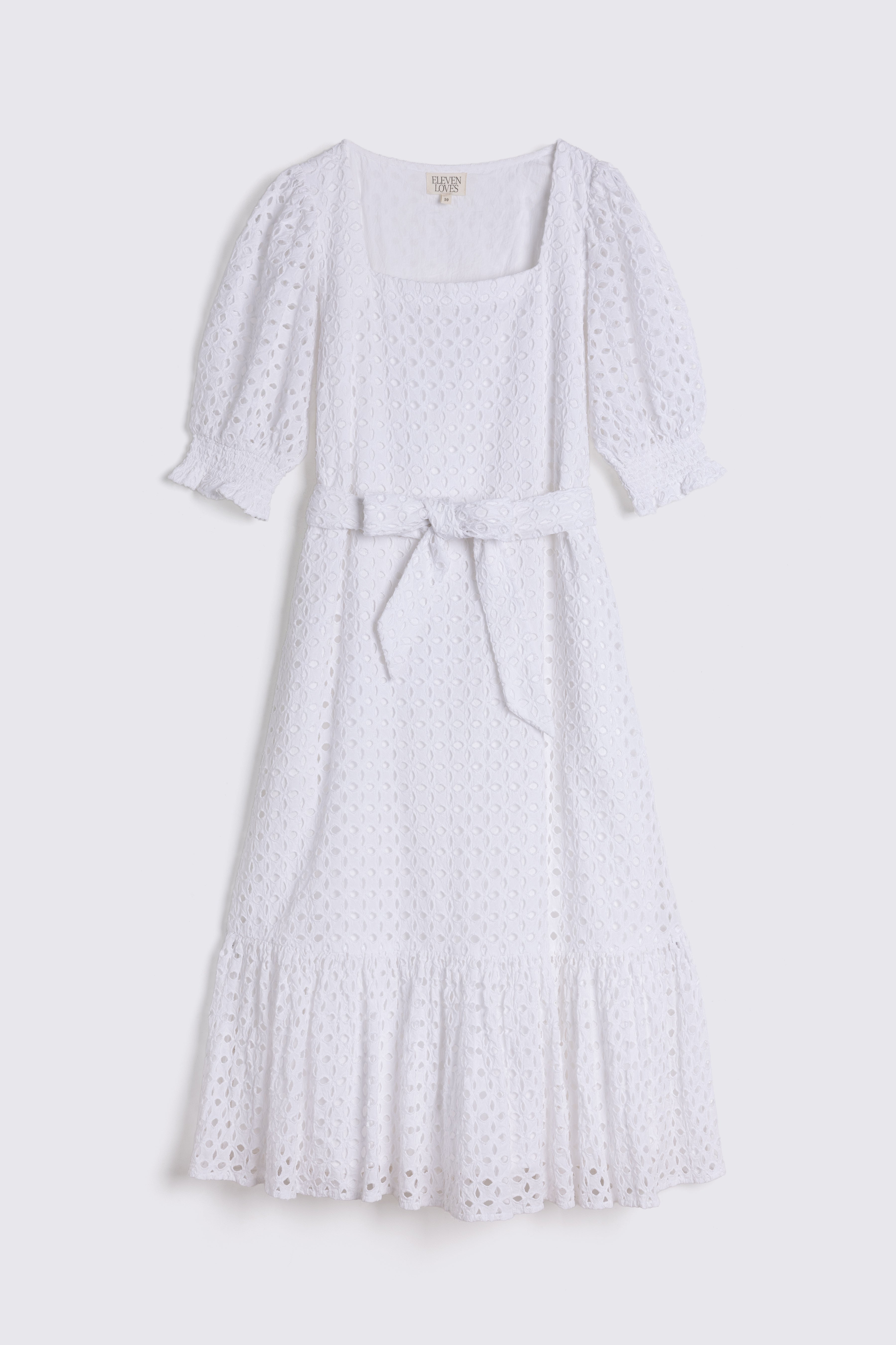 White dress with lace details on a white background