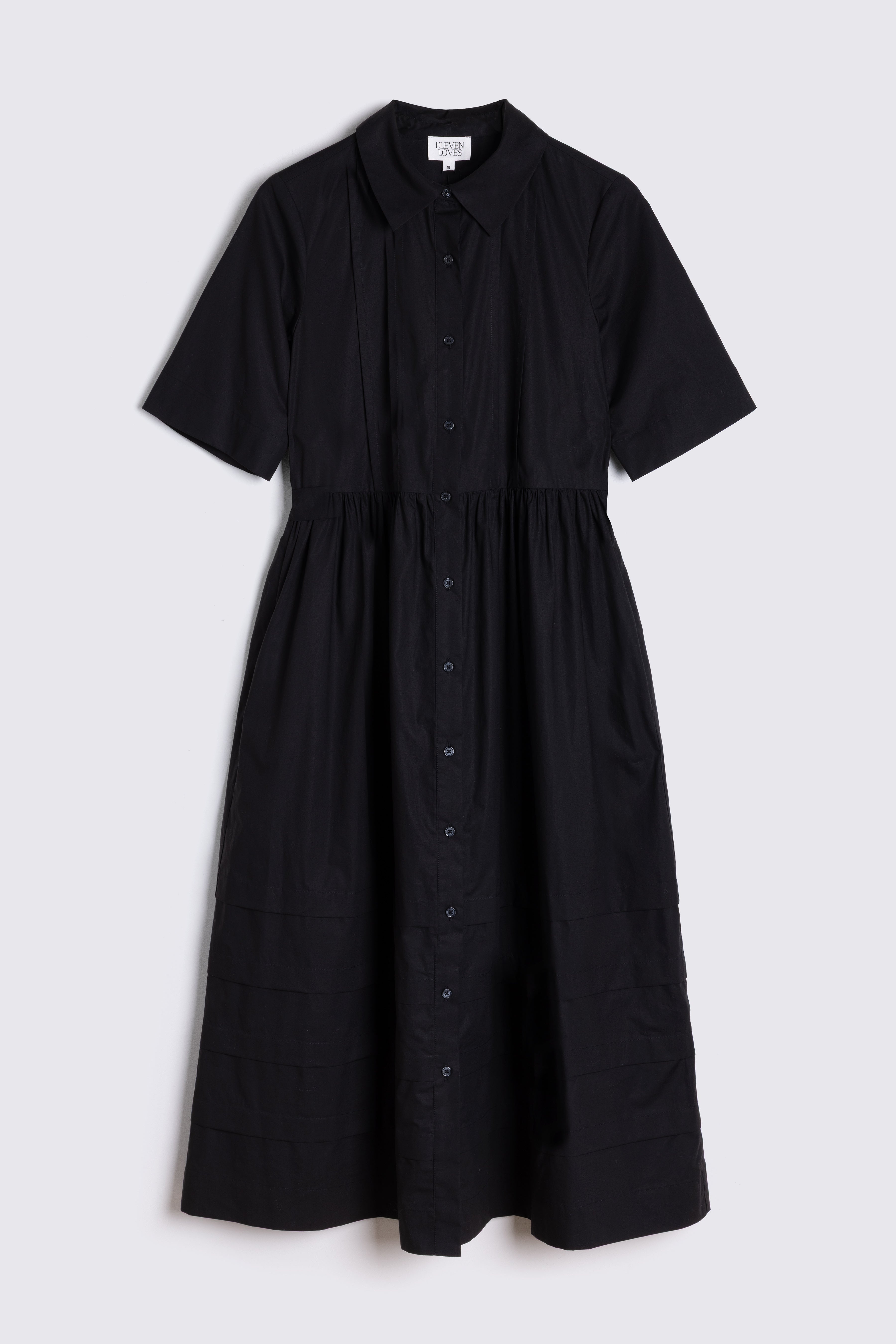 Black dress with short sleeves on a light gray background