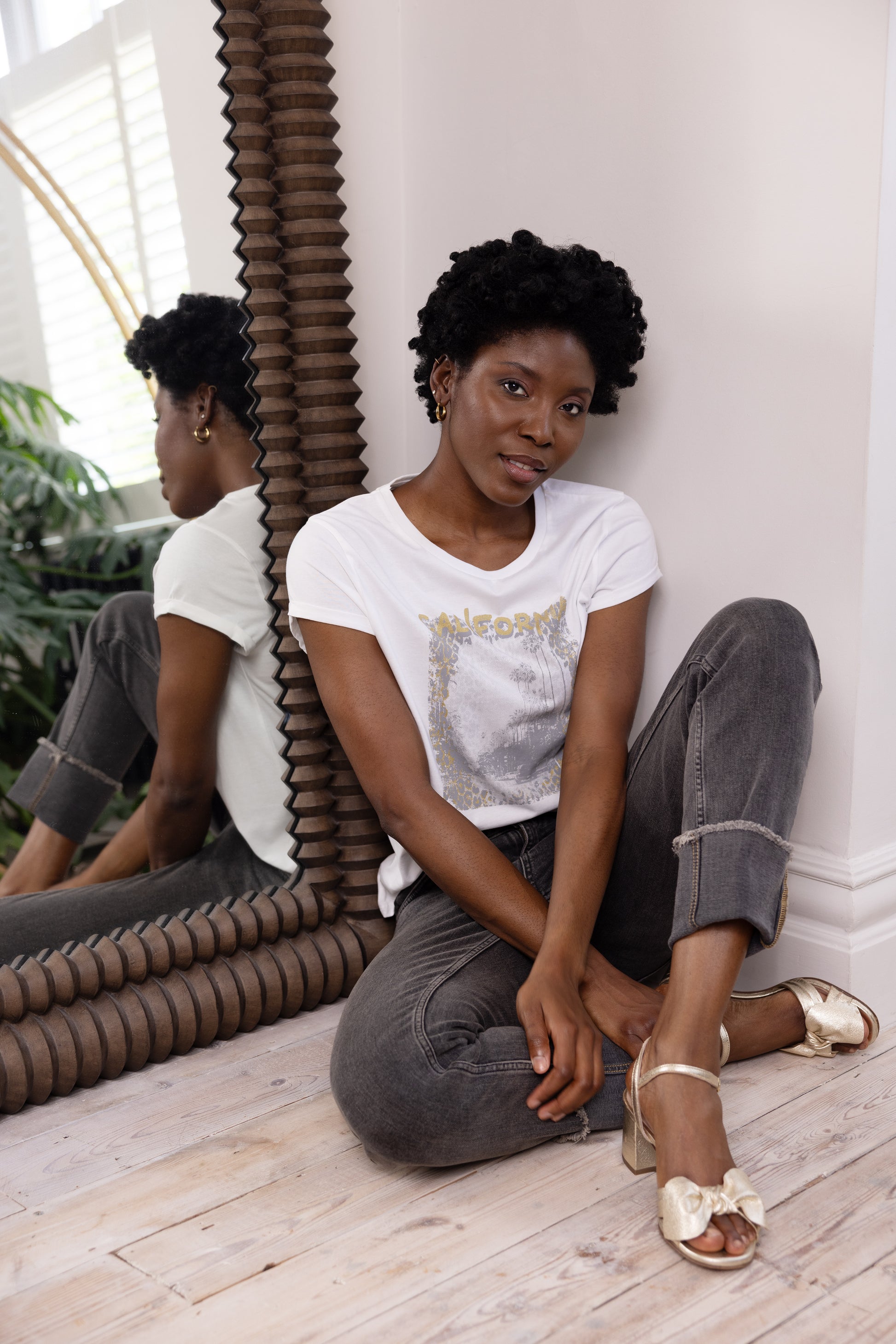 model wearing womens black straight leg jeans with white T Shirt